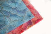 A 3D ribbon and bead embroidery fabric, with feathered petal motifs in a blue gradient.
A 3D ribbon and bead embroidery fabric, with feathered petal motifs in a coral and purple gradient.