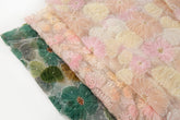 Pink, light green, pale blue, and white crinkle ribbon embroidered floral fabric.
Green, ochre, and grey crinkle ribbon embroidered floral fabric.