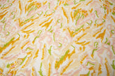 An abstract sequin embroidery fabric with a wavy pattern in yellow, pink, and green.