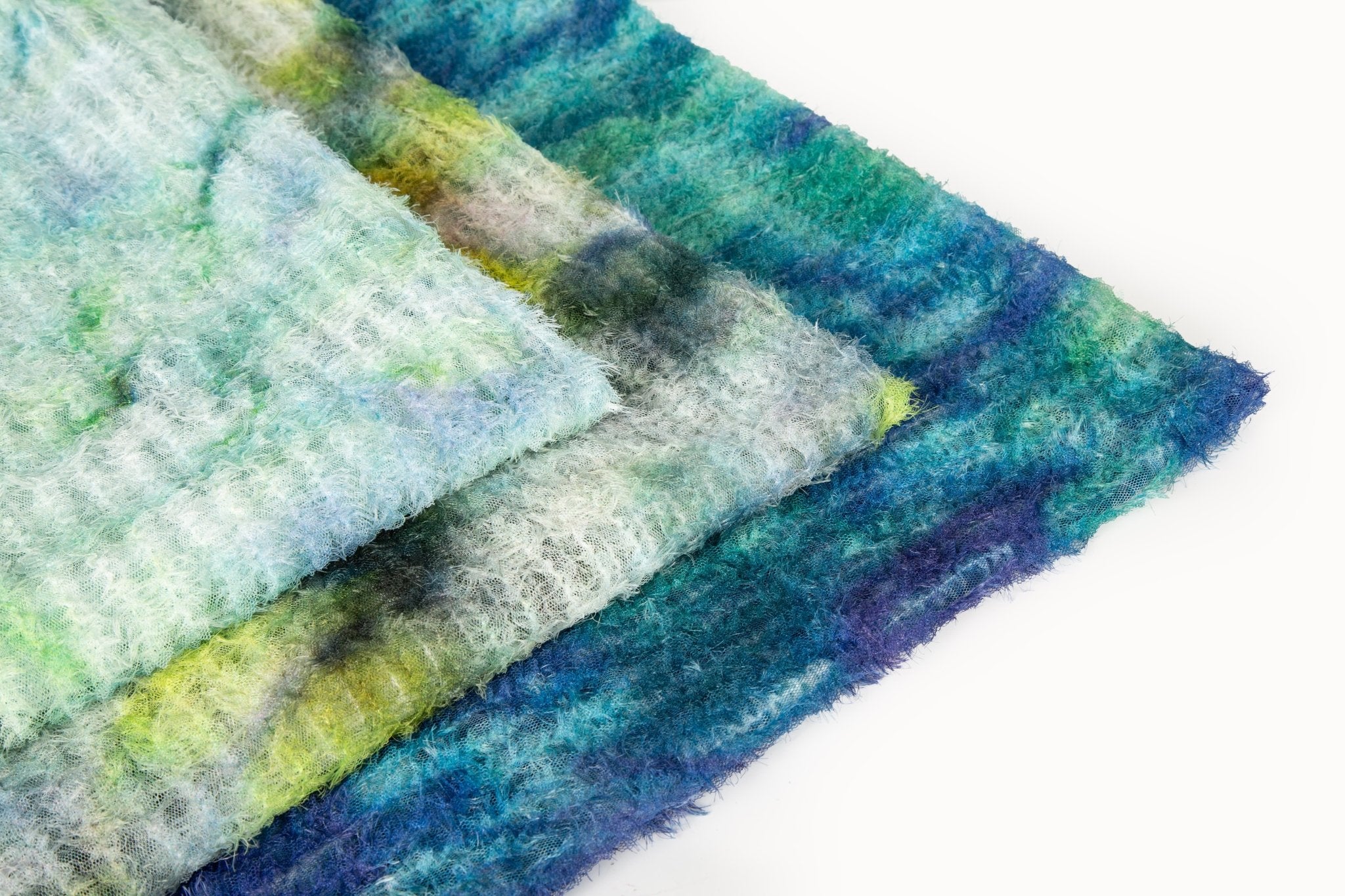    A 3D textured abstract embroidery fabric with a plush feel, in a palette of light green and pale blue.
   A 3D textured abstract embroidery fabric with a plush feel, in a palette of yellow, green, and blue.
   A 3D textured abstract embroidery fabric with a plush feel, in a palette of blue and green