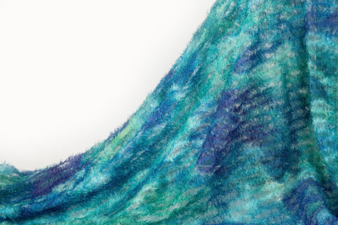 A 3D textured abstract embroidery fabric with a plush feel, in a palette of blue and green