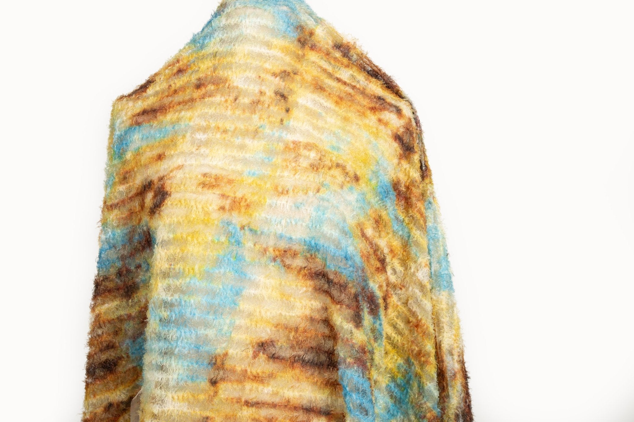 A 3D textured abstract embroidery fabric with a plush feel, in a palette of yellow, blue, and brown.