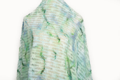A 3D textured abstract embroidery fabric with a plush feel, in a palette of light green and pale blue.
