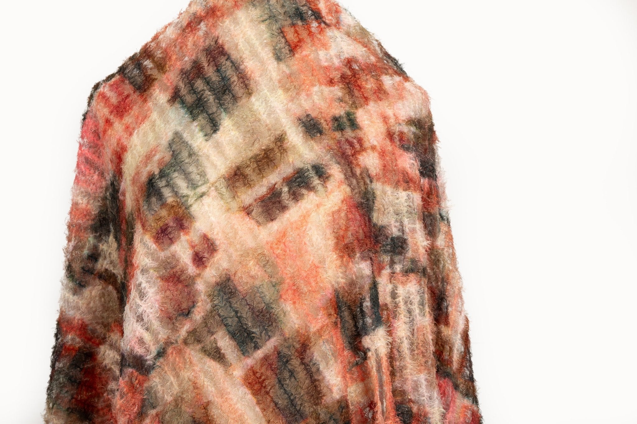 A 3D textured abstract embroidery fabric with a plush feel, in a palette of red, orange, and brown.
