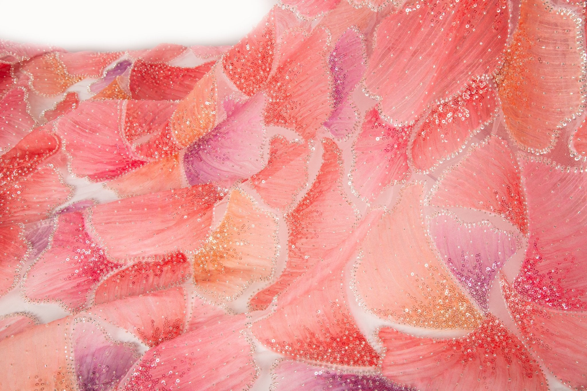 A 3D ribbon and bead embroidery fabric, with feathered petal motifs in a coral and purple gradient.
