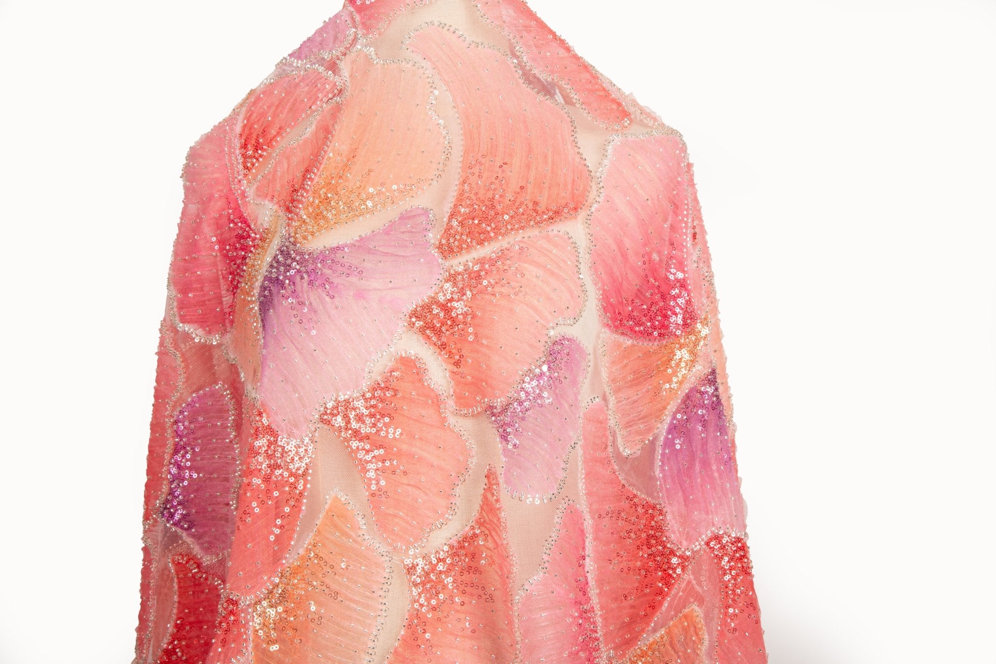 A 3D ribbon and bead embroidery fabric, with feathered petal motifs in a coral and purple gradient.
