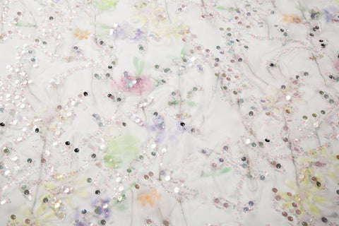 A 3D ruched embroidery fabric with a soft texture, in a palette of mint green, lilac, and pink.
