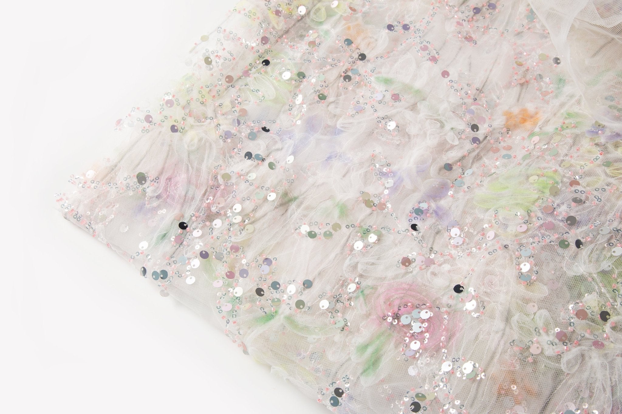 A 3D ruched embroidery fabric with a soft texture, in a palette of mint green, lilac, and pink.
