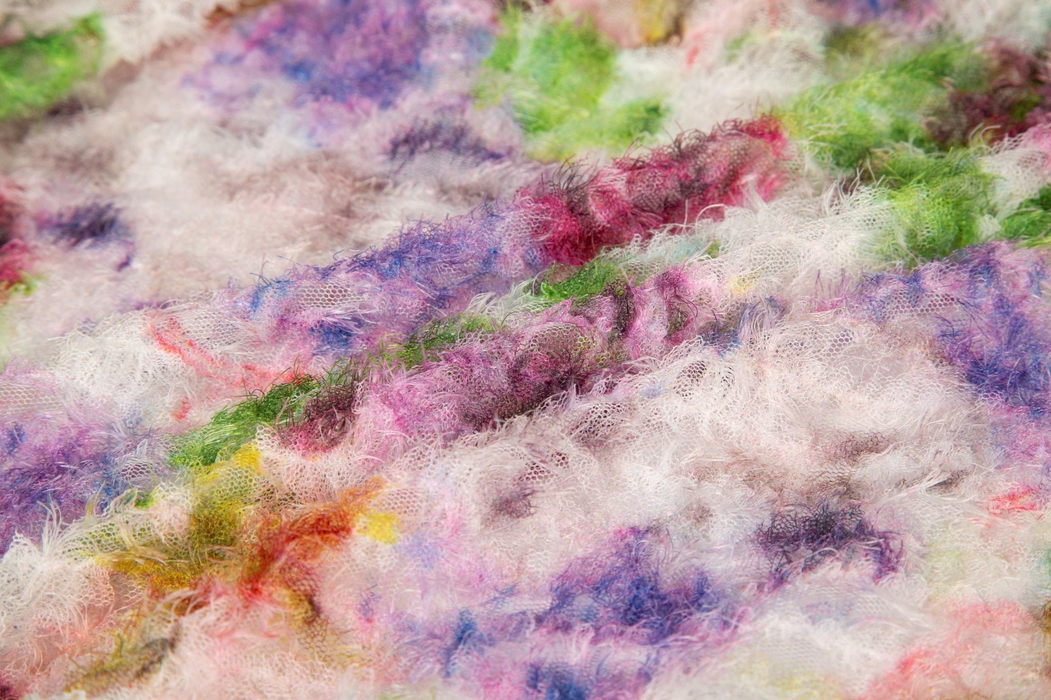 A 3D textured embroidery fabric with a plush feel, in a palette of purple, pink, and green.
