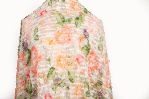 A 3D textured embroidery fabric with a plush feel, in a palette of peach, pink, and green.
