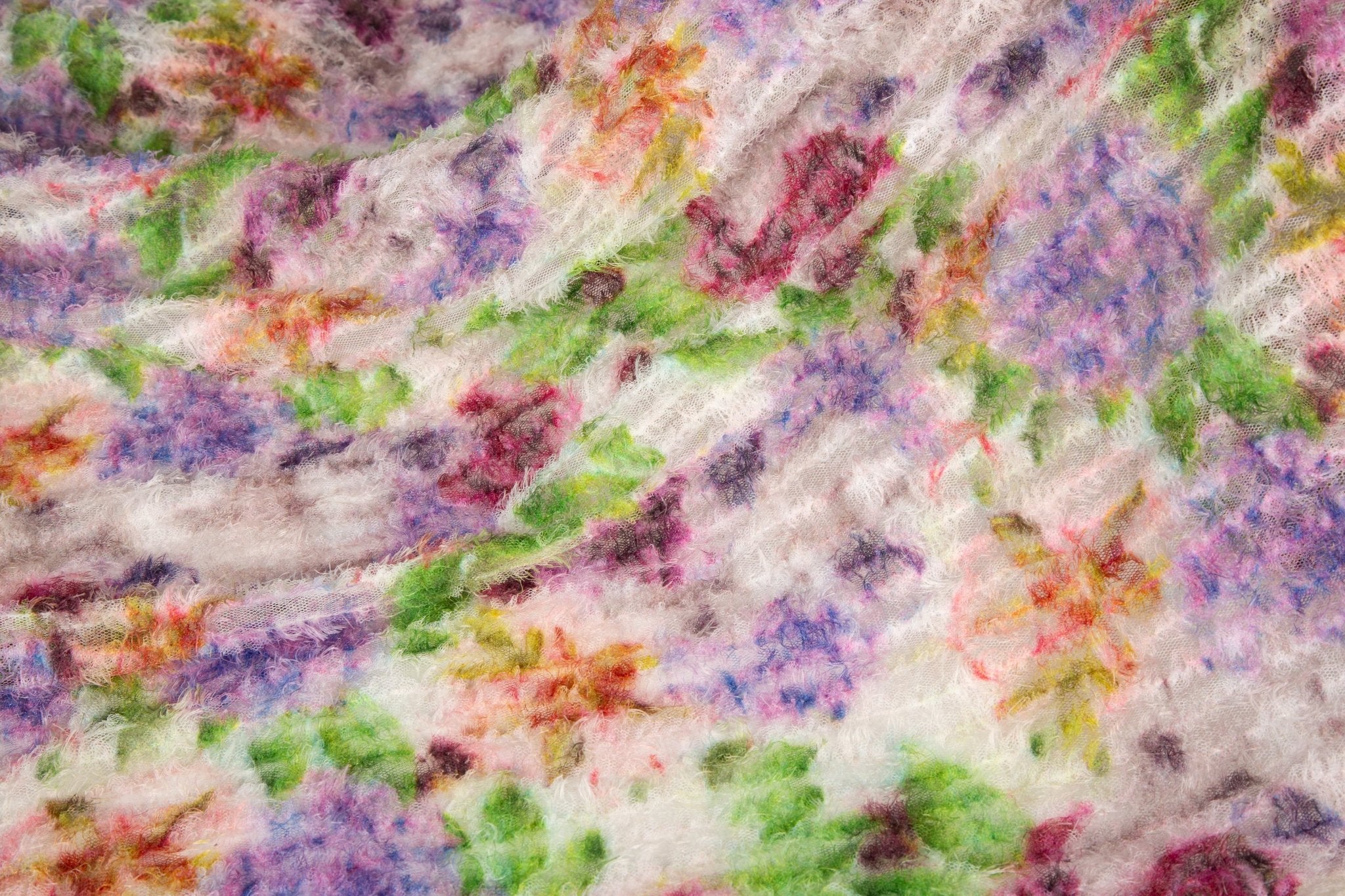 A 3D textured embroidery fabric with a plush feel, in a palette of purple, pink, and green.
