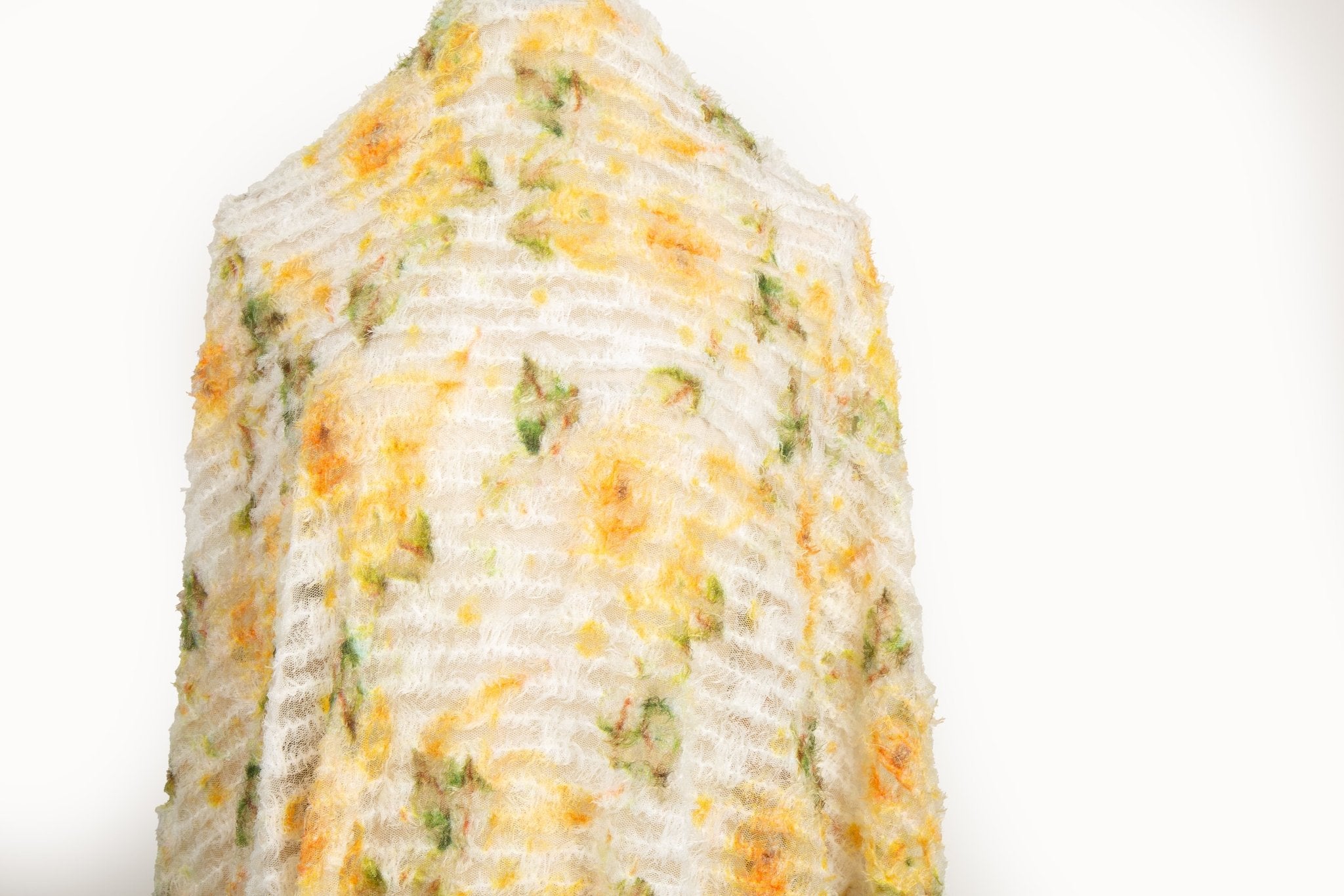  A 3D textured embroidery fabric with a plush feel, in a palette of yellow and green.
