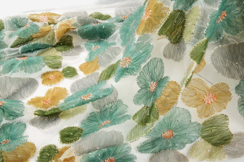 Green, ochre, and grey crinkle ribbon embroidered floral fabric.