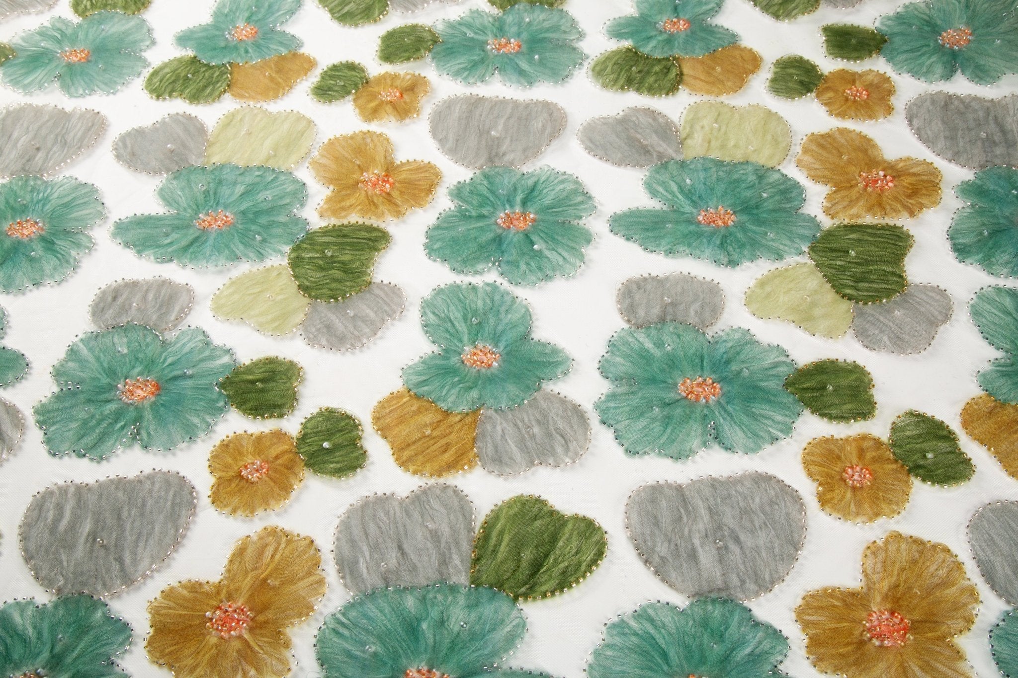 Green, ochre, and grey crinkle ribbon embroidered floral fabric.