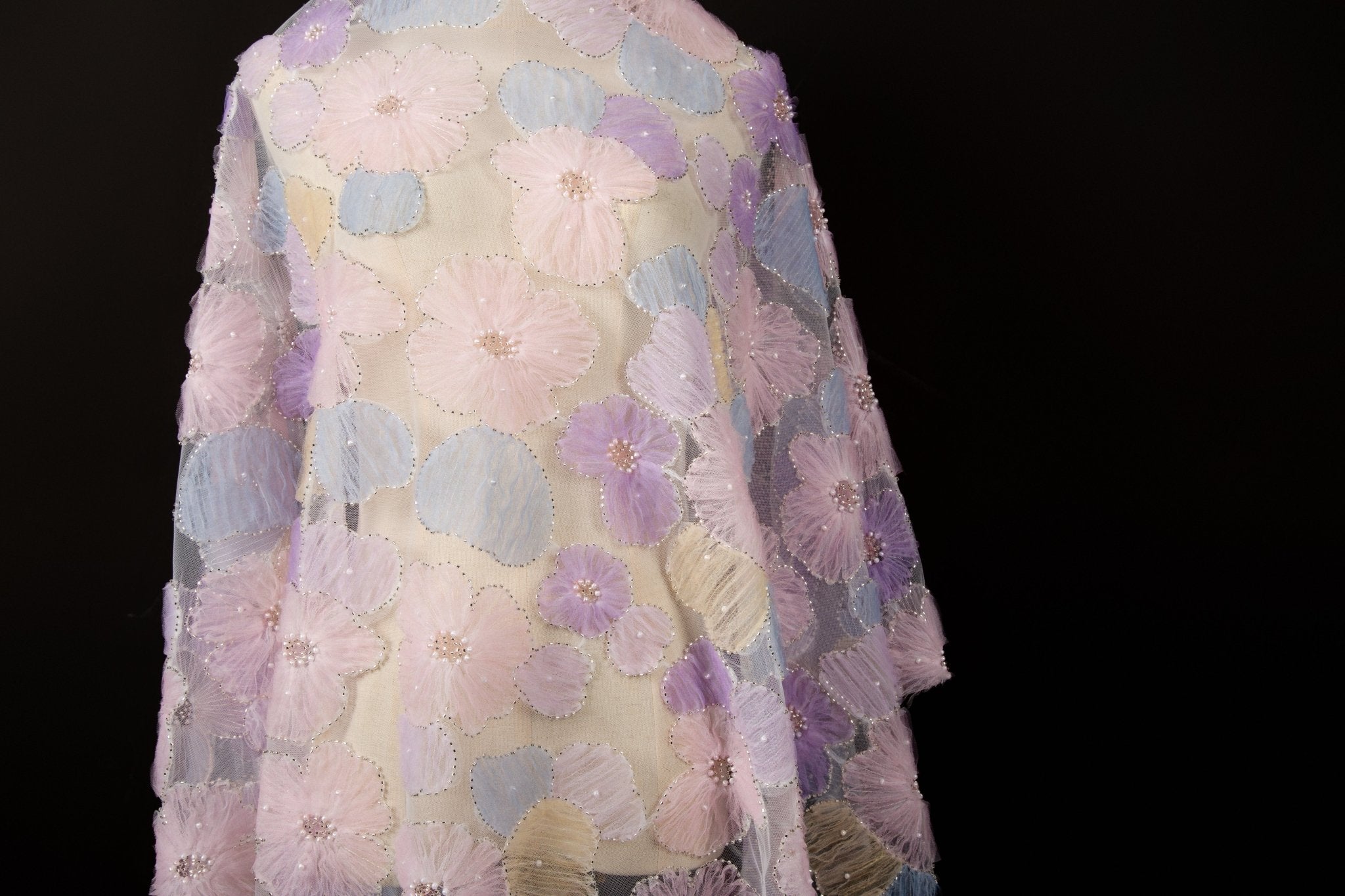  Pink, yellow, and peach crinkle ribbon embroidered floral fabric.