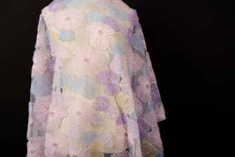  Pink, yellow, and peach crinkle ribbon embroidered floral fabric.