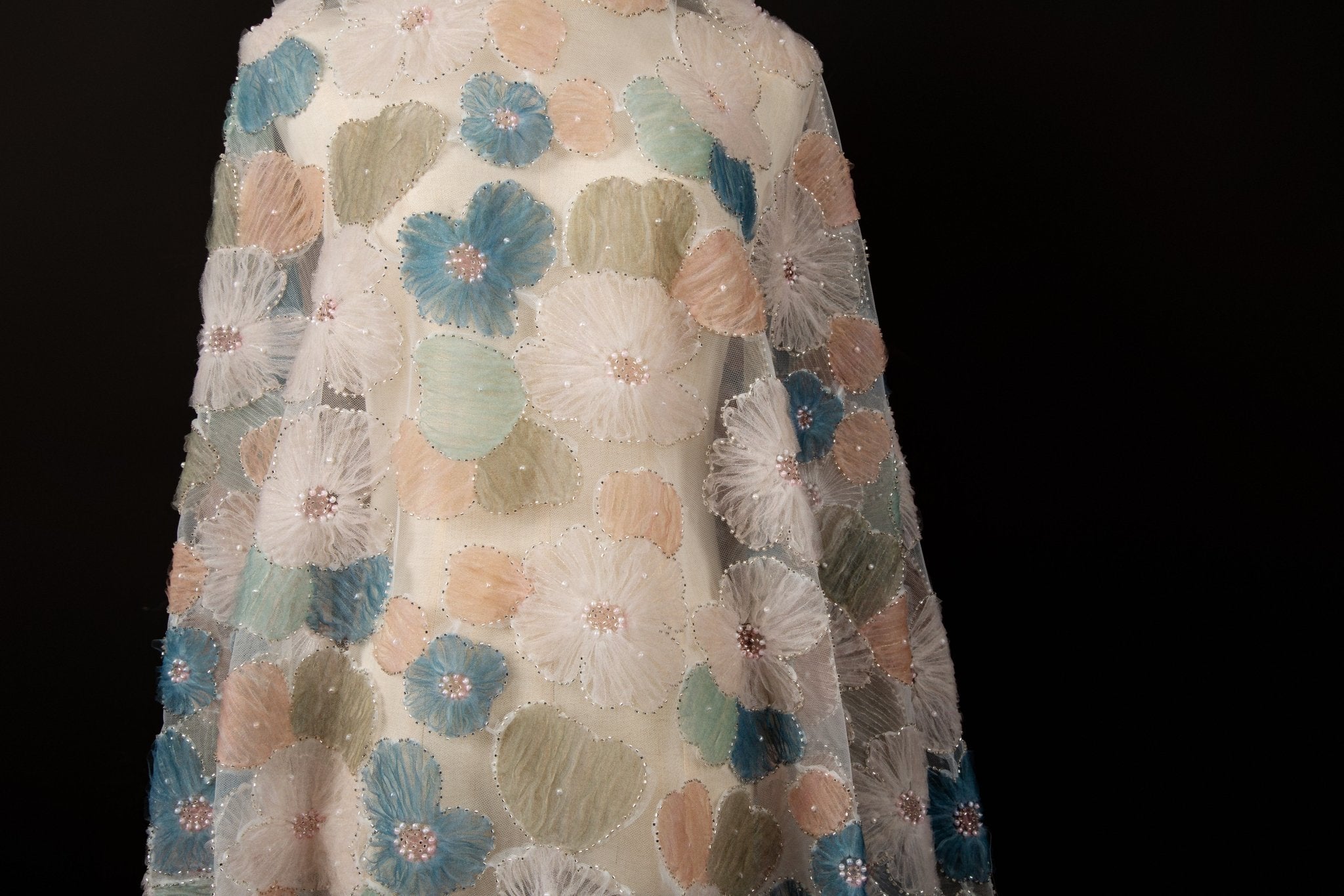  Lavender, pale blue, and soft yellow crinkle ribbon embroidered floral fabric.
