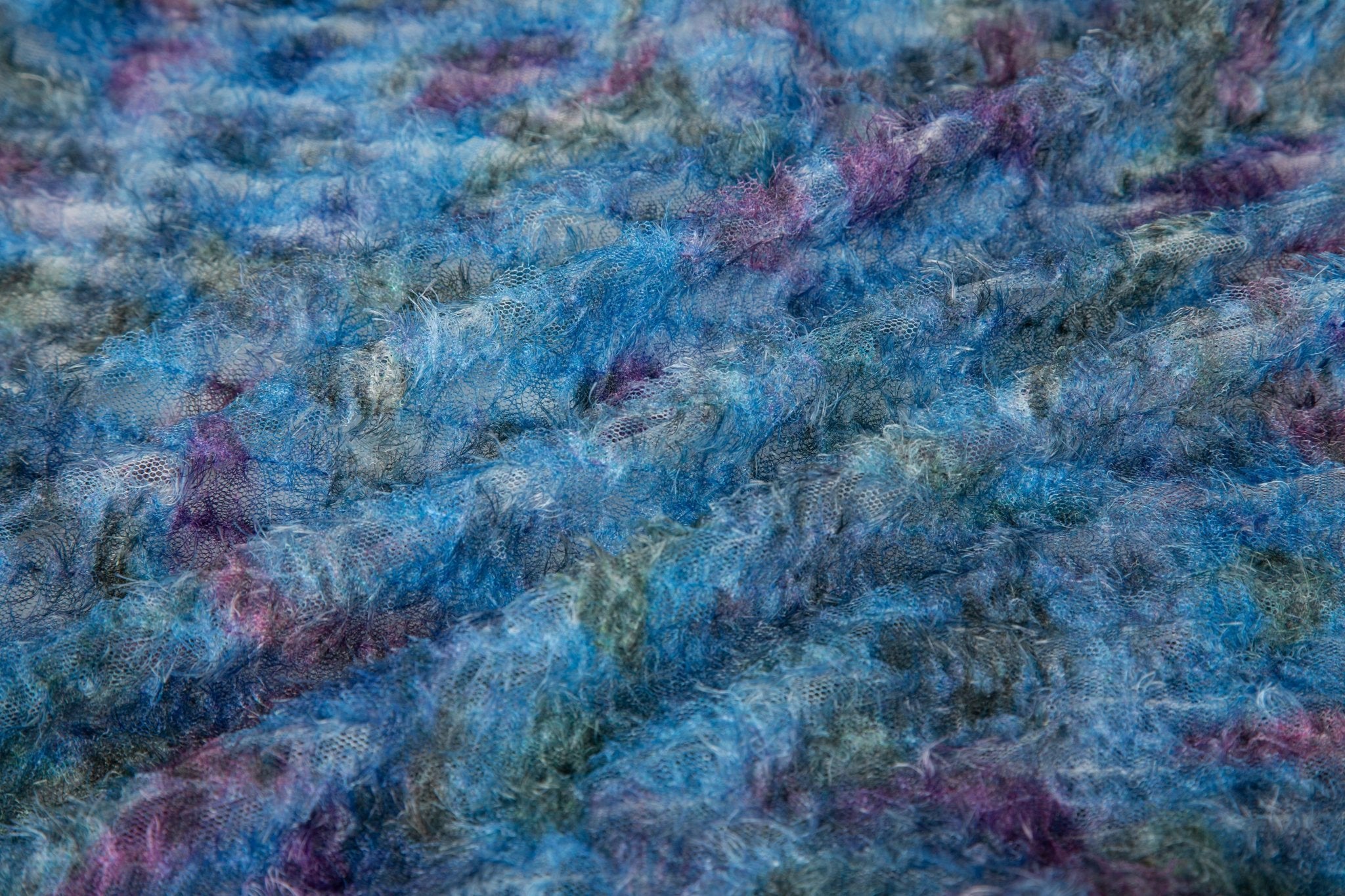 A 3D textured, plaid-patterned embroidery fabric with a plush feel, in a palette of various blues and teals.
