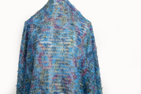 A 3D textured, plaid-patterned embroidery fabric with a plush feel, in a palette of various blues and teals.
