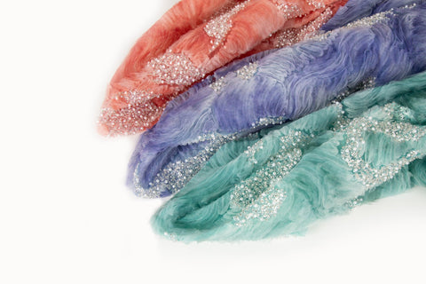    A 3D ribbon and beaded embroidery fabric in coral pink.
   A 3D ribbon and beaded embroidery fabric in lilac purple.
   A 3D ribbon and beaded embroidery fabric in mint green.