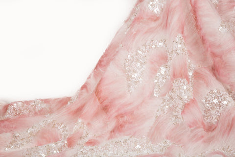 A 3D ribbon and beaded embroidery fabric in light coral.
