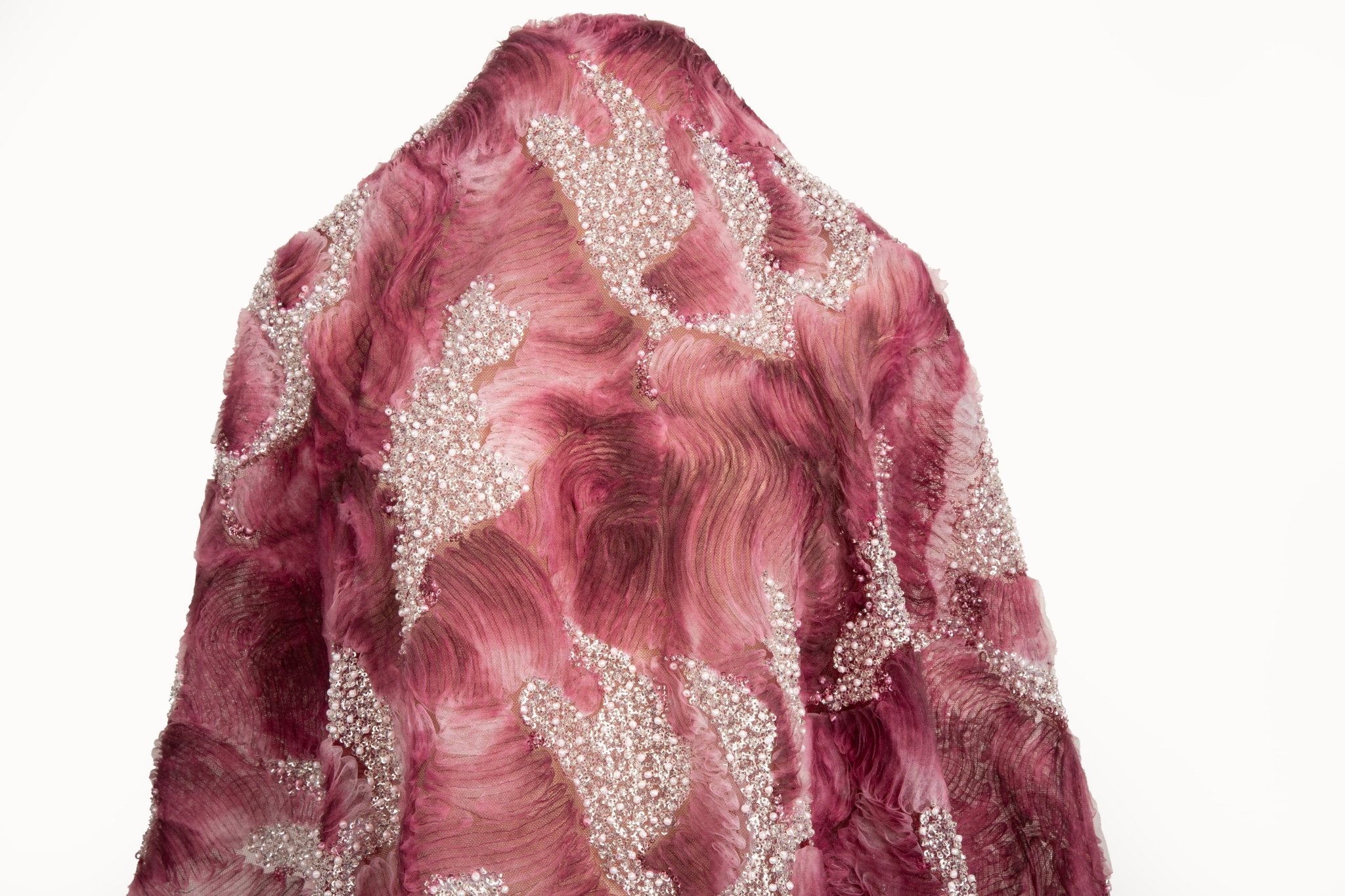 A 3D ribbon and beaded embroidery fabric in burgundy.
