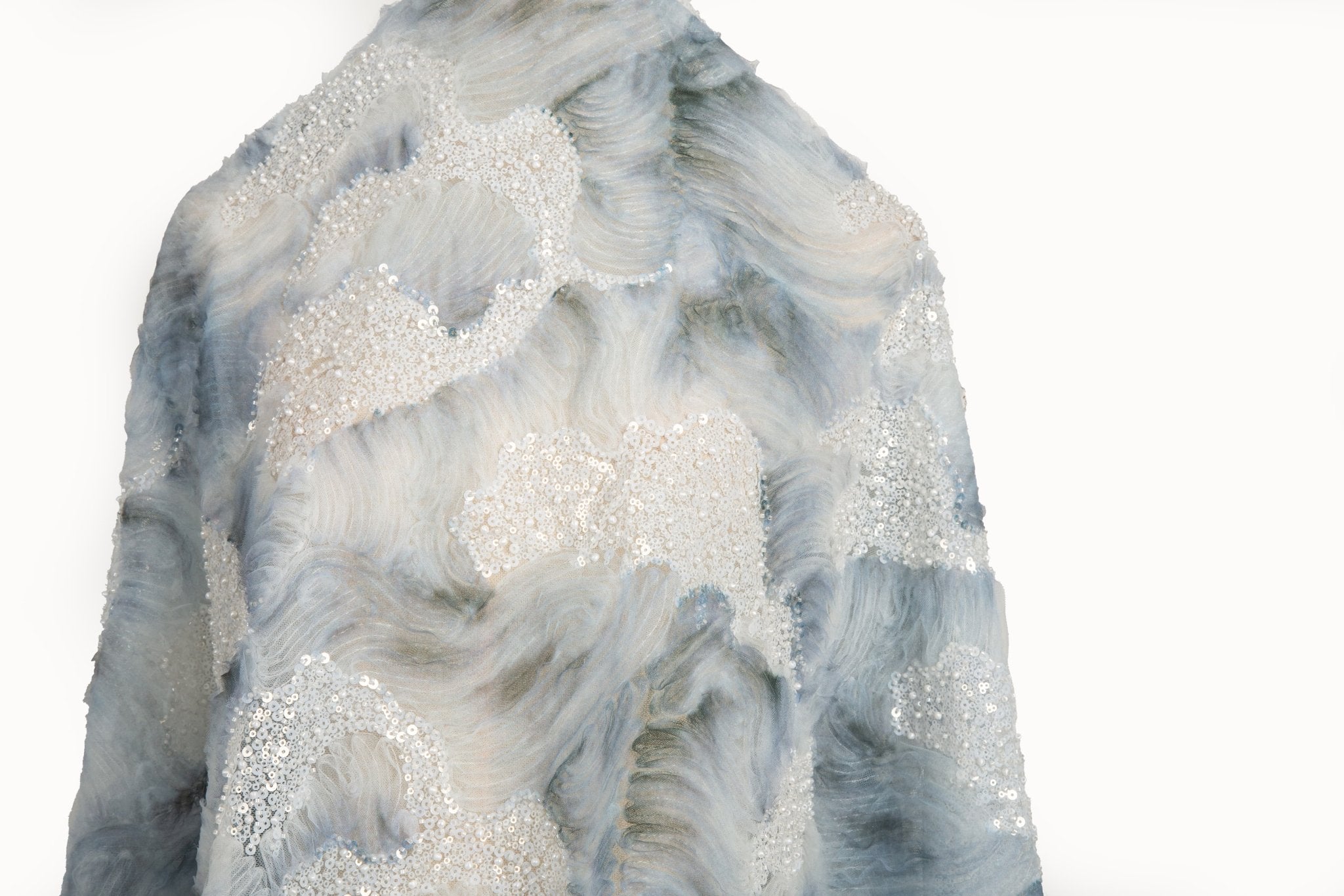  A 3D ribbon and beaded embroidery fabric in dusty blue.
