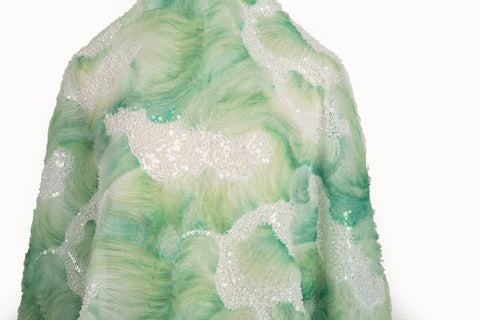 A 3D ribbon and beaded embroidery fabric in lime green.
