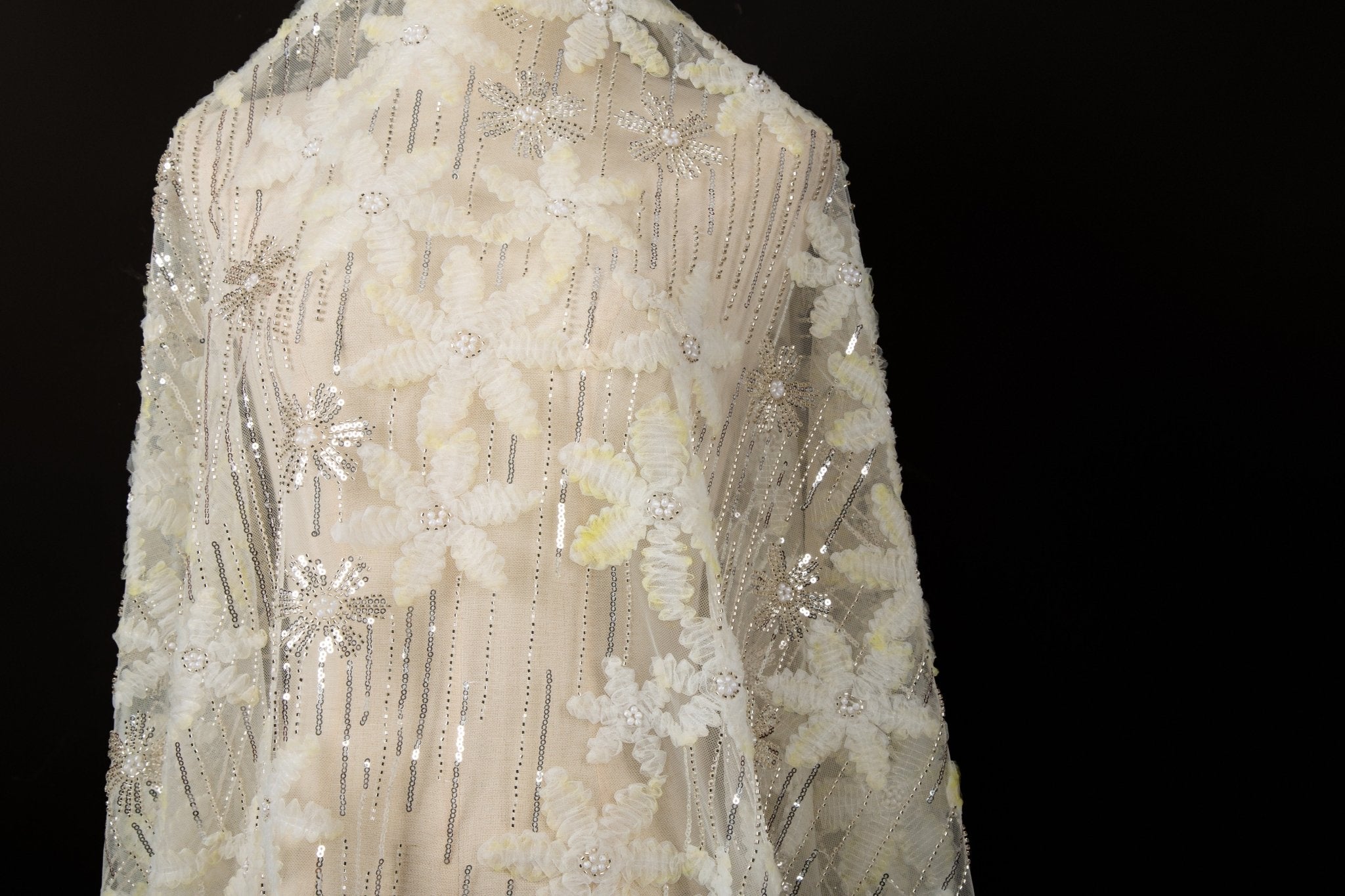 Yellow 3D textured floral and silver sequin embroidery fabric.