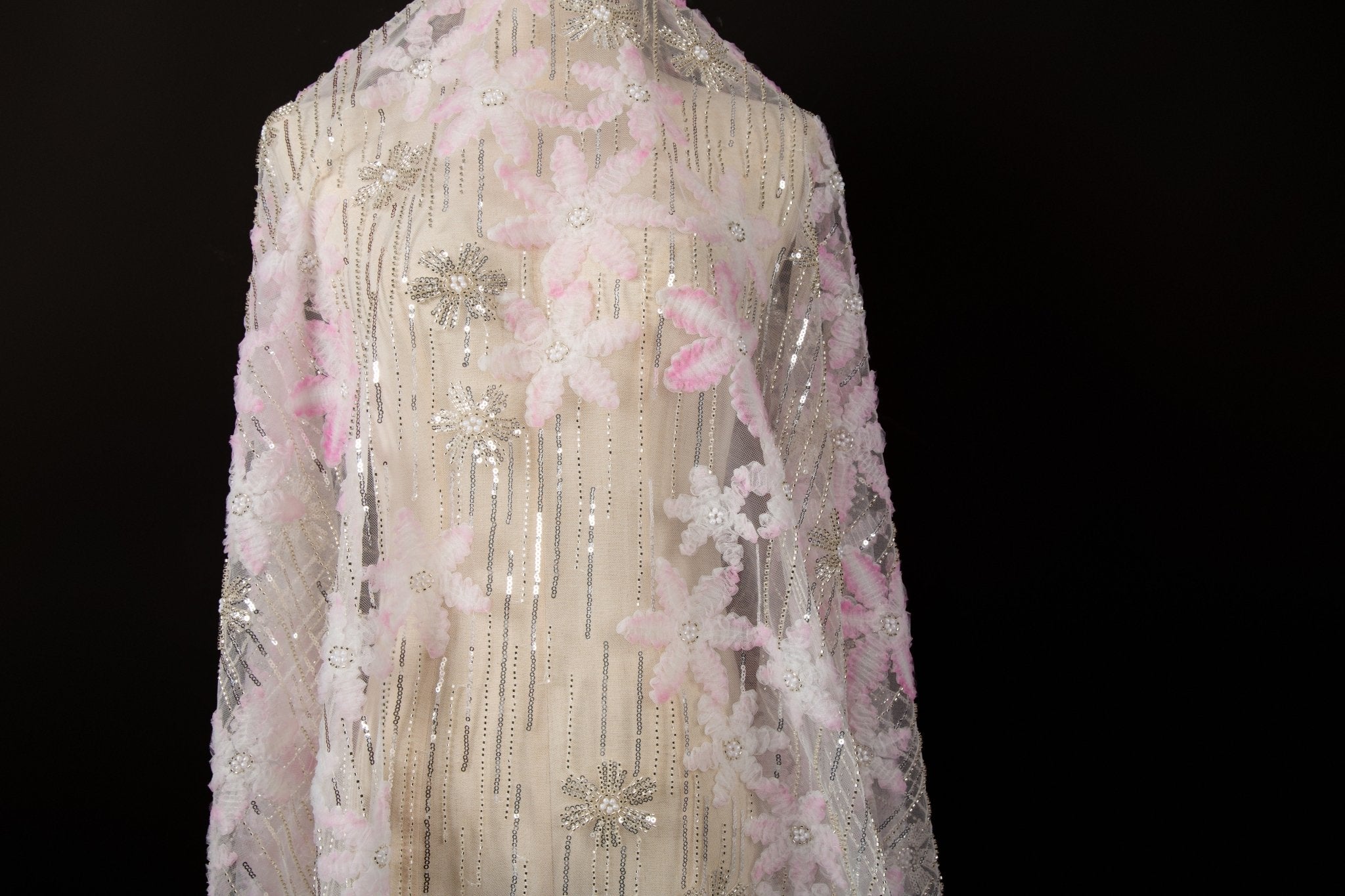 Pink 3D textured floral and silver sequin embroidery fabric.