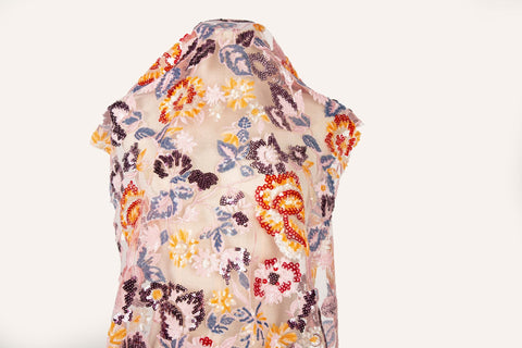 A sequin floral embroidery fabric on a nude base, with multi-color pastel motifs.