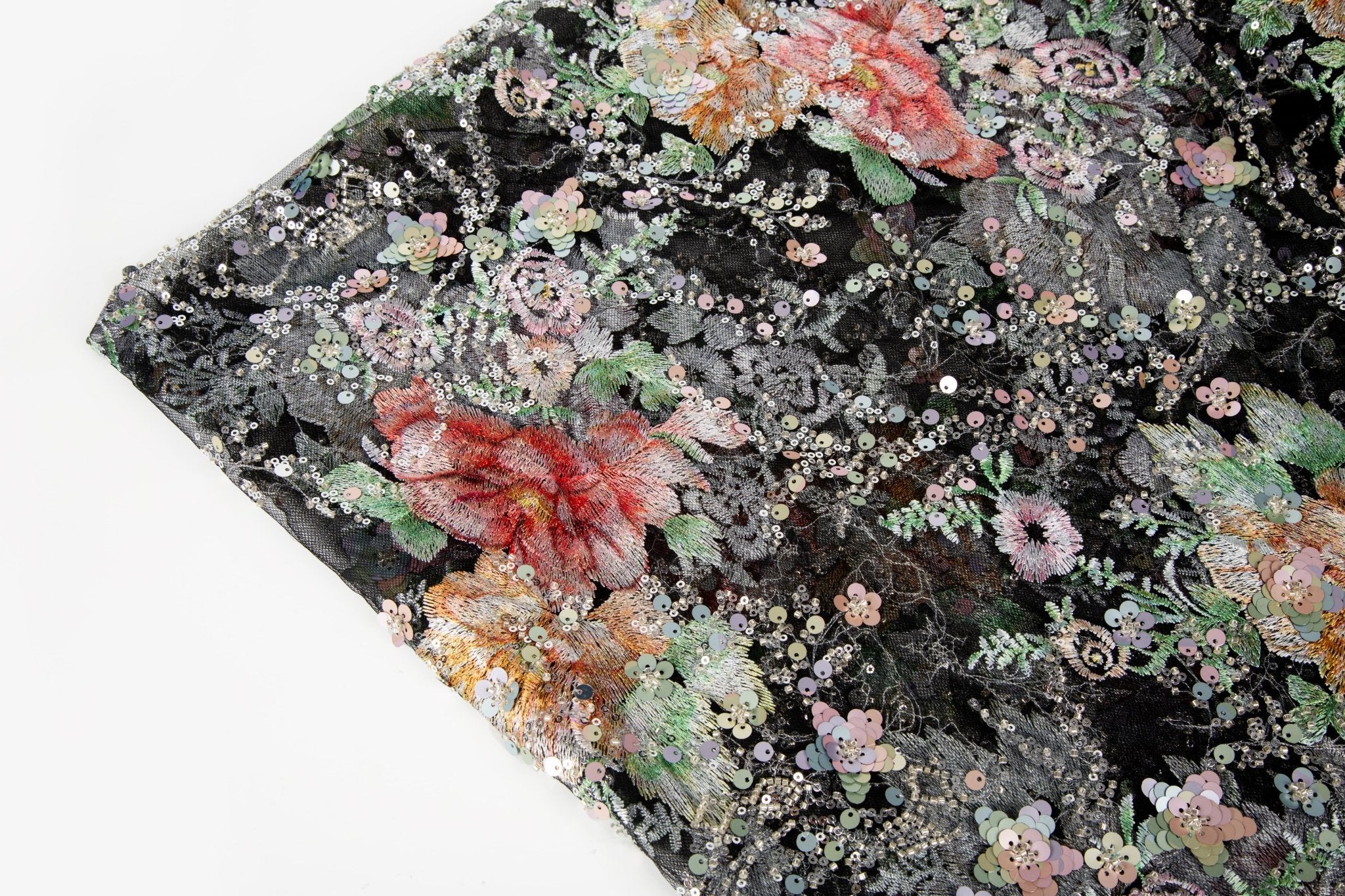 A painterly floral sequin and thread embroidery fabric on a black mesh base with richly colored flowers.

