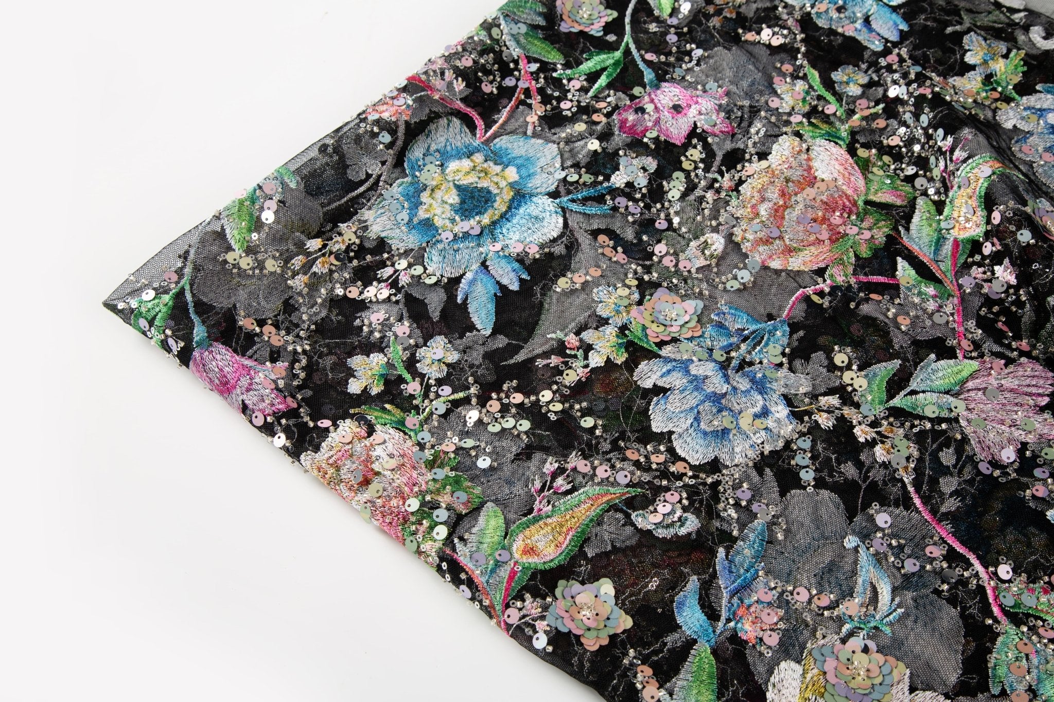 A multi-color floral sequin embroidery fabric on a black mesh base.
