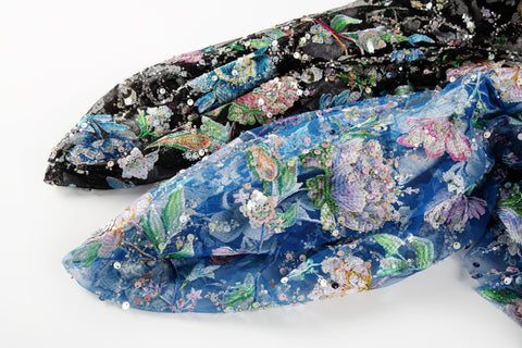   A multi-color floral sequin embroidery fabric on a black mesh base.
  A multi-color floral sequin embroidery fabric on a sapphire blue mesh base.