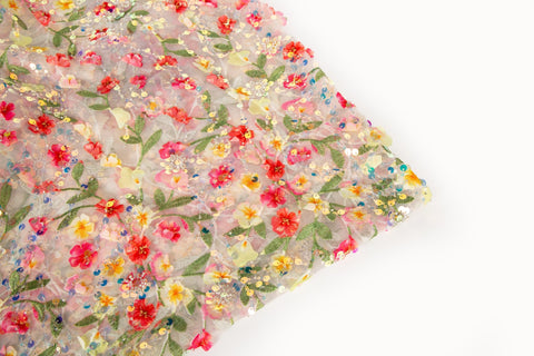 A 3D embroidery fabric with a multi-color wildflower pattern, embellished with sequins and beads.
