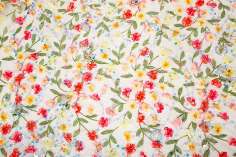 A 3D embroidery fabric with a multi-color wildflower pattern, embellished with sequins and beads.

